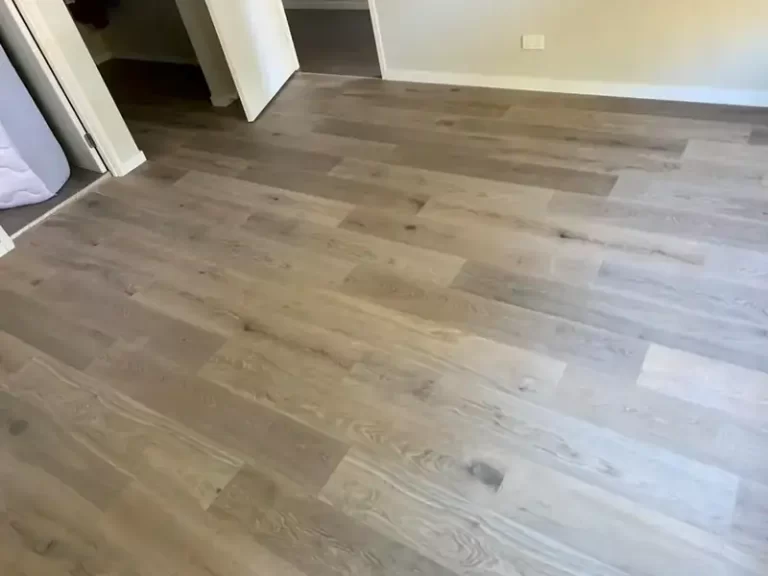 Timber-look plank flooring running through an open-plan living and dining area in a Sydney home